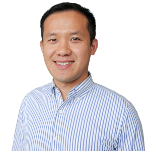 Asian man with short dark hair wearing a blue and white striped button up shirt.
