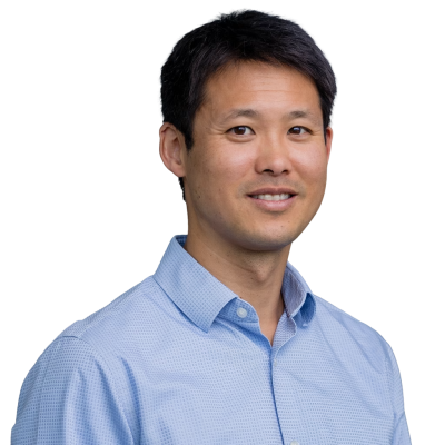 Asian man with short dark hair who is wearing a light blue shirt
