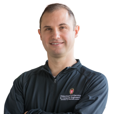White man with very short brown hair wearing a dark gray polo shirt with the UW-Madison logo on it.