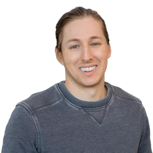 White man with blond hair wearing a gray sweatshirt