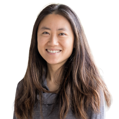 Asian woman with long dark brown hair and wearing a gray sweater.
