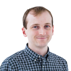 White male with a small amount of reddish brown hair wearing a dark blue plaid button-down shirt.