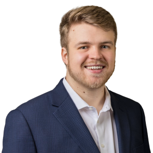 White man with light brown hair wearing a navy jacket