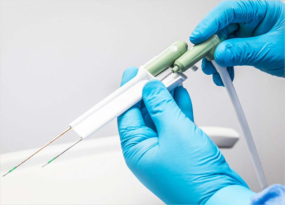Image of the NeuWave device that looks like two needs encased in a white case and held in two hands.