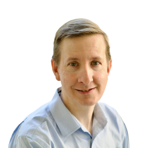 White man with short blond hair wearing a white button down shirt.