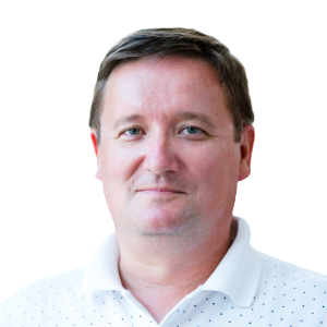 White man with short dark brown hair wearing a white button-down shirt.