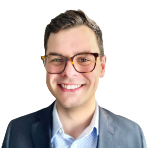 White man with short brown hair wearing glasses and a gray suit jacket.