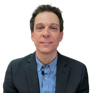 White man with short dark brown hair wearing a blue shirt and a gray suit jacket.