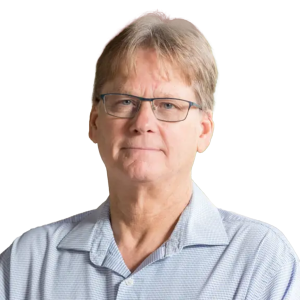 Mature white man with light blond hair wearing glasses and a light blue button down shirt.