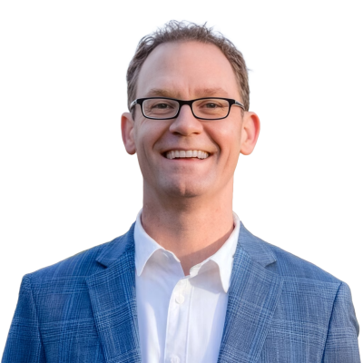 White man with short light brown hair wearing glasses, a white shirt, and light blue suit jacket.