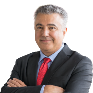 Mature white male with short gray hair wearing a black suit jacket and red tie.