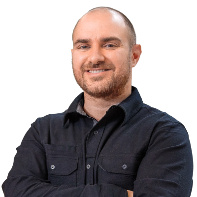 White man with very short hair and facial hair wearing a black button down shirt.