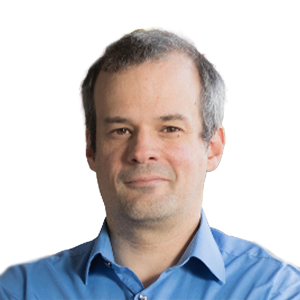 White man with short gray hair wearing a blue button down shirt.