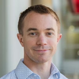 headshot of a white man with short brown hair